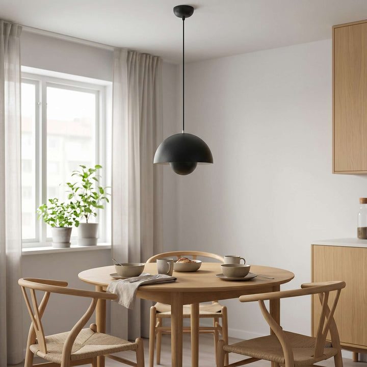 Matte black Flowerpot pendant lamp shown above a dining table.