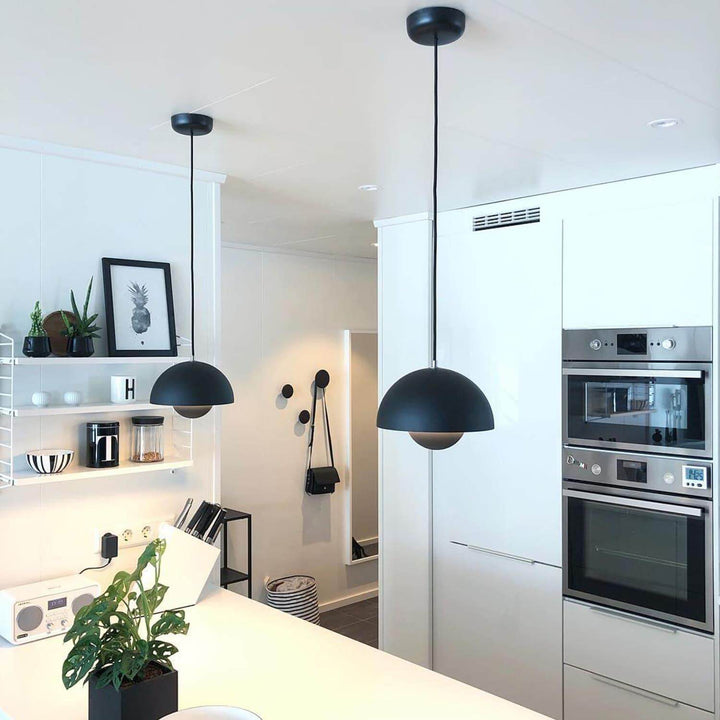 Matte black Flowerpot pendant lamps shown over a kitchen counter.