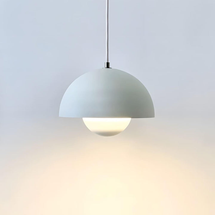 Matte white Flowerpot pendant lamp shown against a wall.