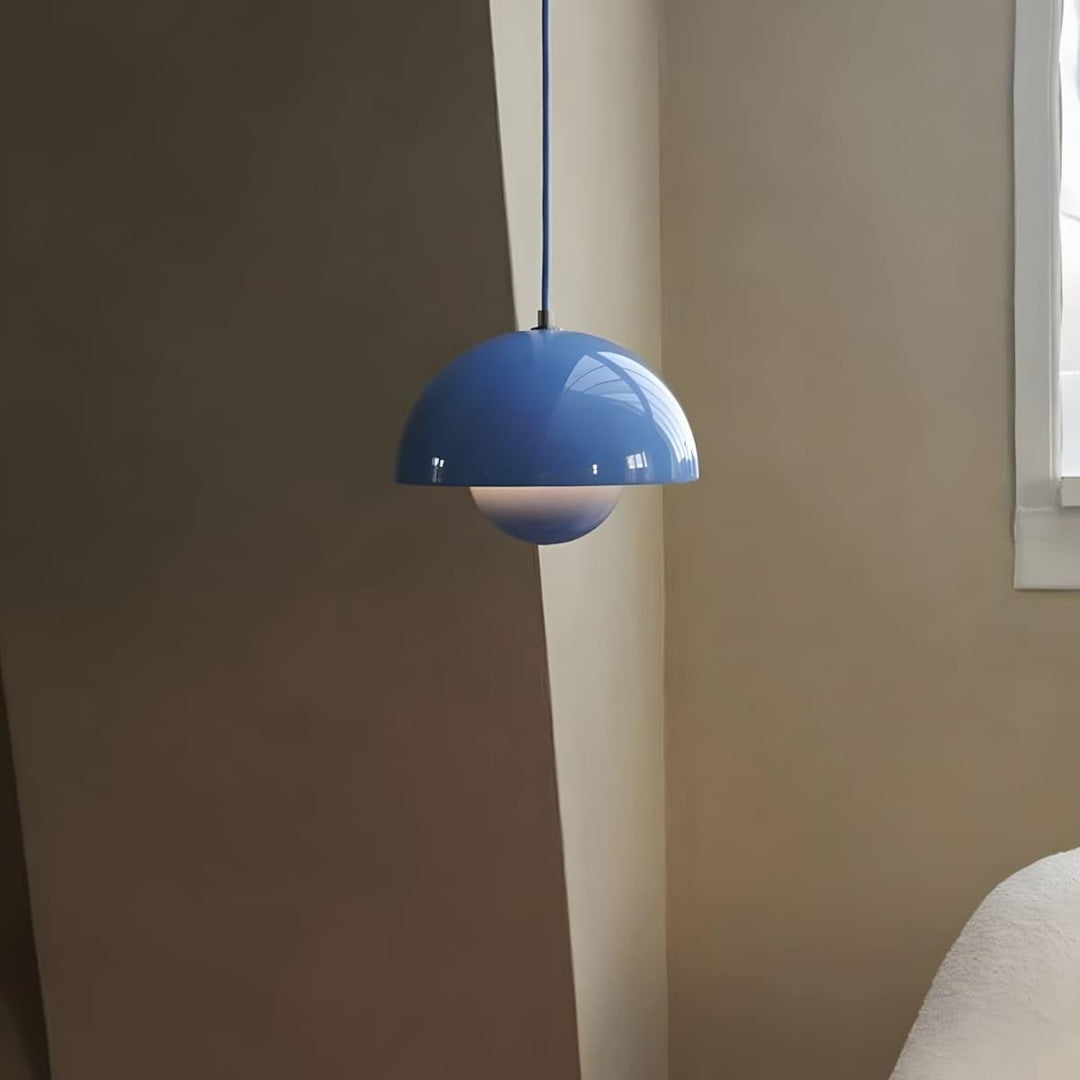 Sky blue Flowerpot pendant lamp shown beside a window.