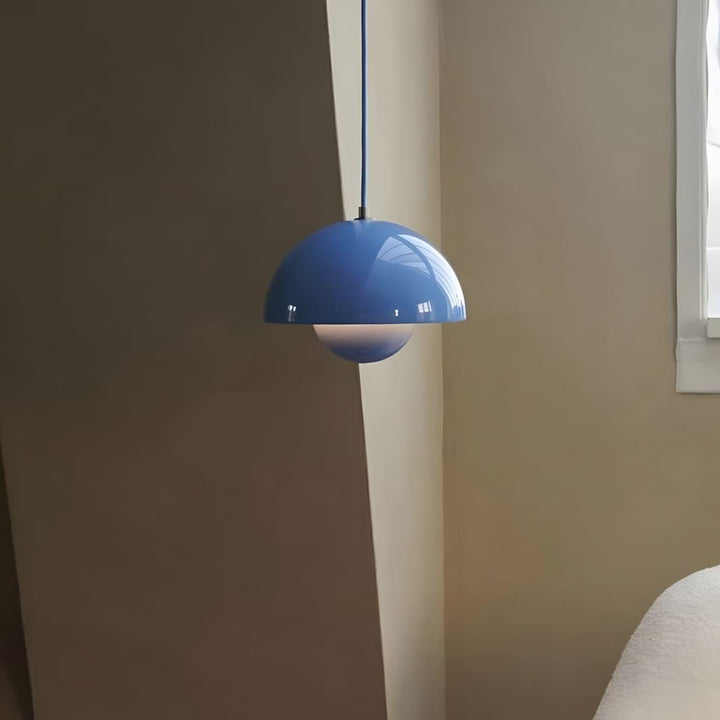 Sky blue Flowerpot pendant lamp shown beside a window.
