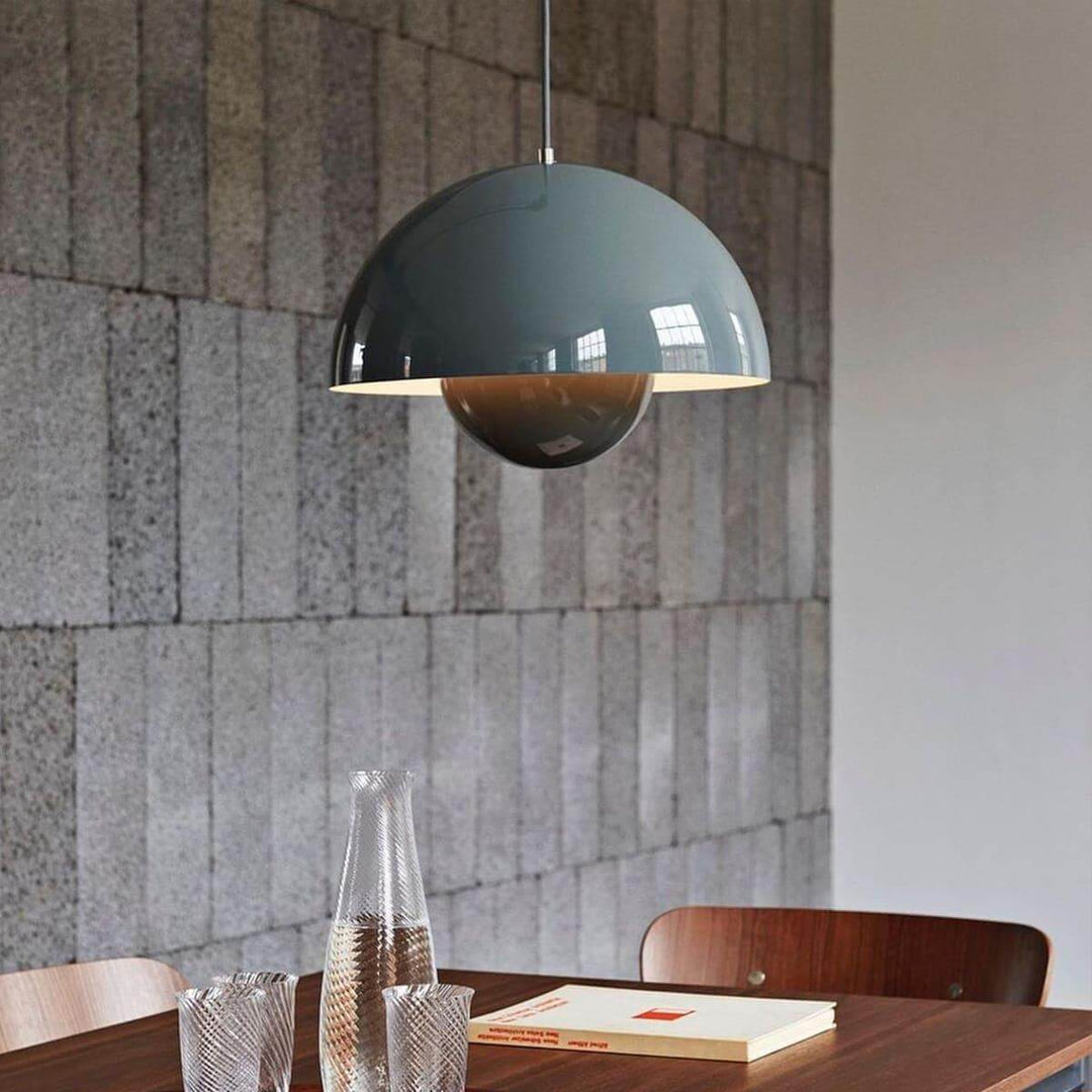 Stone blue Flowerpot pendant lamp shown in a restaurant-style dining setting.