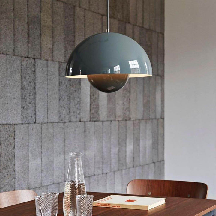 Stone blue Flowerpot pendant lamp shown in a restaurant-style dining setting.