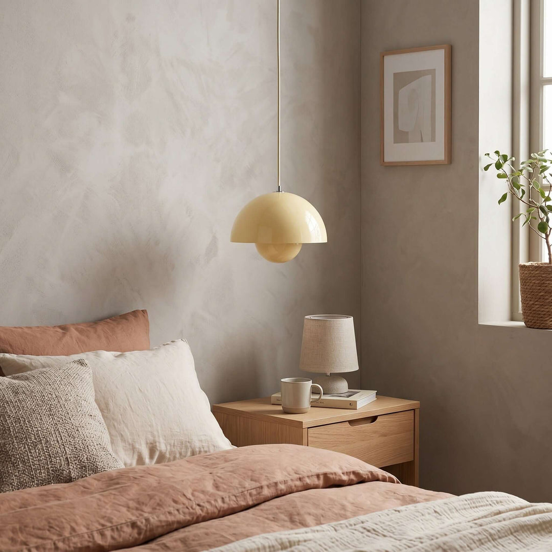 Yellow Flowerpot pendant lamp shown beside a bed.