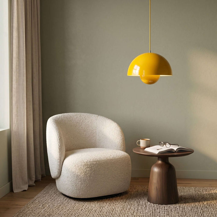 Yellow Flowerpot pendant lamp shown above a lounge chair.