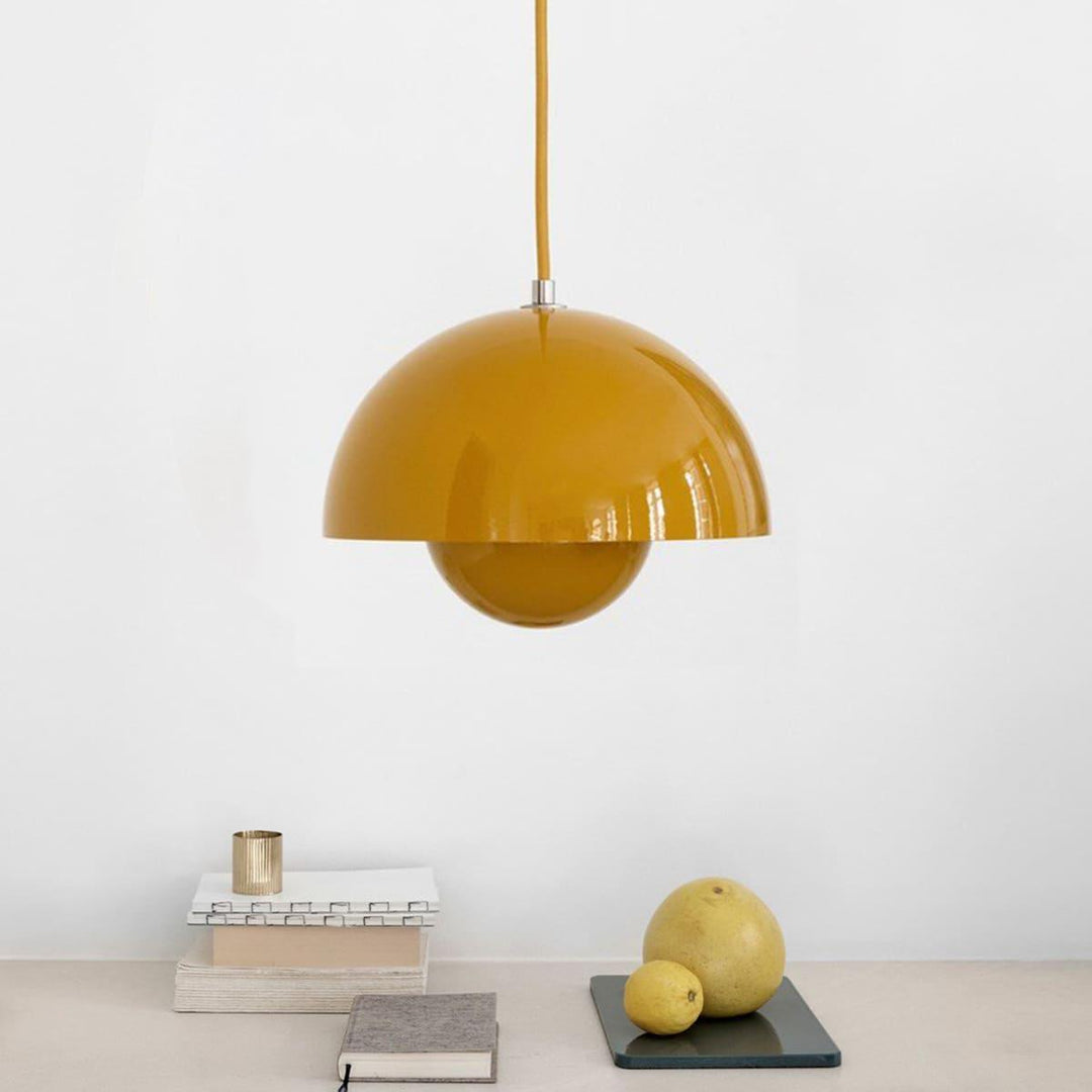 Yellow Flowerpot pendant lamp shown above a small shelf.