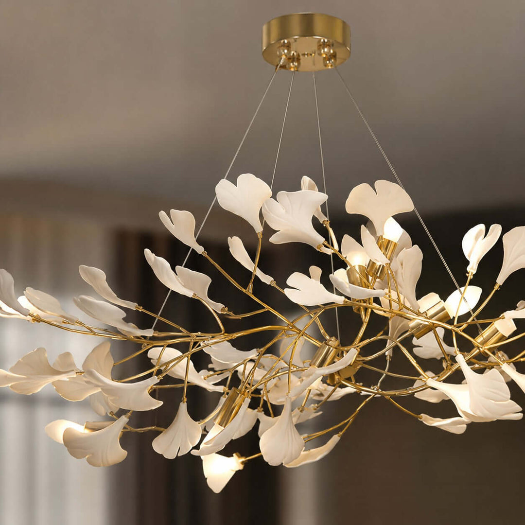 Close-up of the rose gold ceiling canopy and suspended wires on the Gingko chandelier.