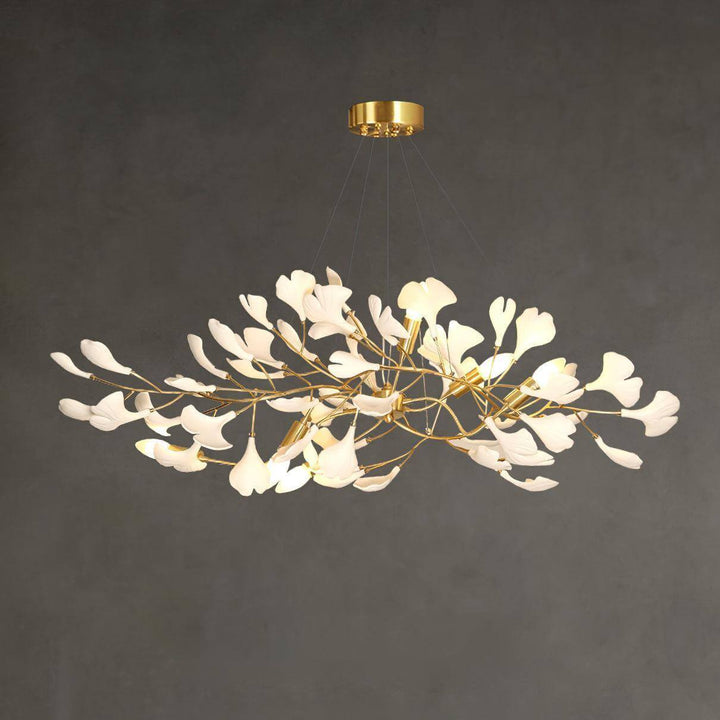 Angled view of the Gingko ceramic leaf chandelier with rose gold frame on a gray background.

