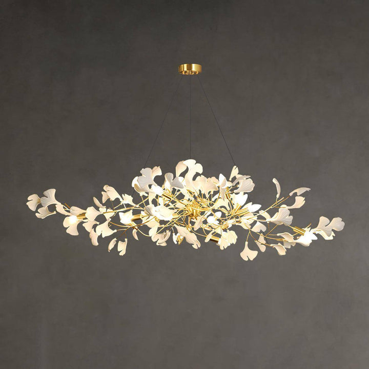 Wide view of the Gingko ceramic leaf chandelier lit against a gray background.