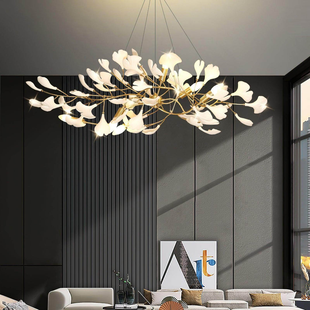 Gingko ceramic leaf chandelier glowing in a living room with tall gray wall panels.