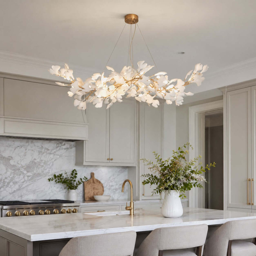 Ceramic leaf chandelier shown close above a kitchen counter and sink area.