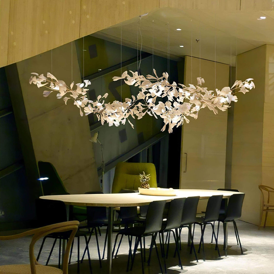 Gingko ceramic leaf chandelier above a kitchen island in a warm night scene.