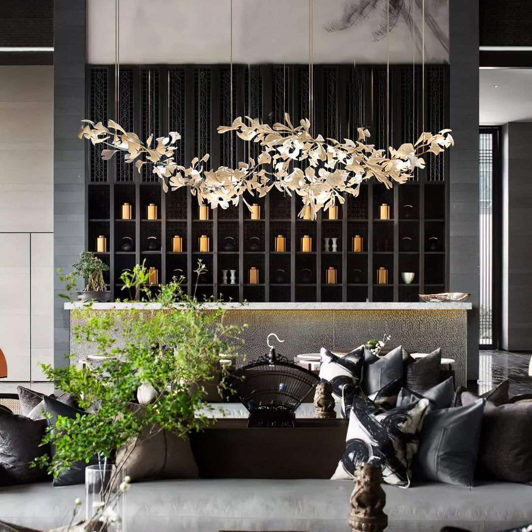 Ceramic leaf chandelier above a lounge seating area with dark wall shelving.