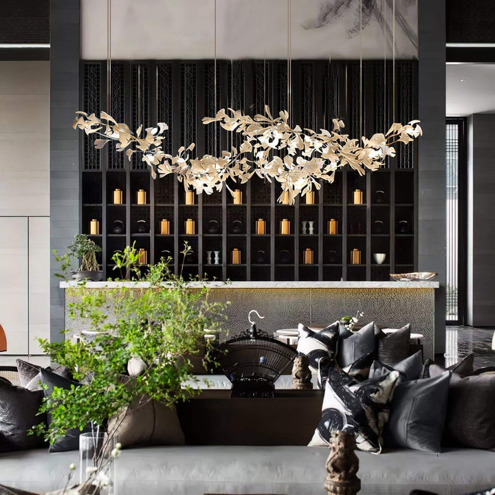 Ceramic leaf chandelier above a lounge seating area with dark wall shelving.