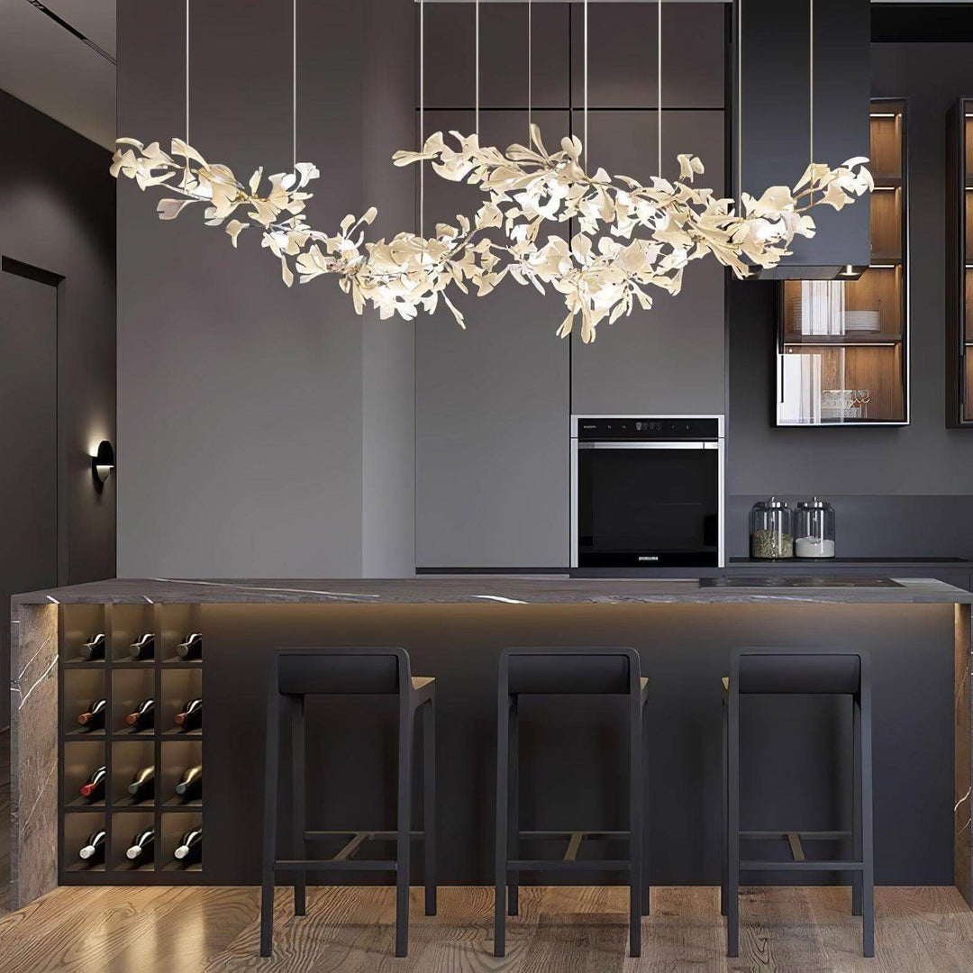 Ceramic leaf chandelier above a dark kitchen bar with stools.