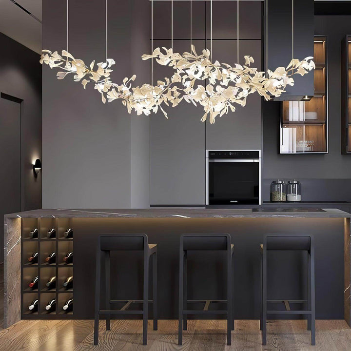 Ceramic leaf chandelier above a dark kitchen bar with stools.