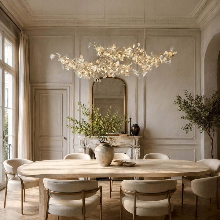 Gingko chandelier with ceramic leaves above a formal dining table.