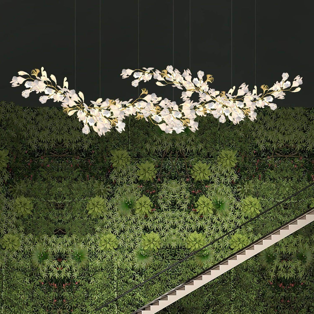 Gingko ceramic leaf chandelier shown against a green wall backdrop.