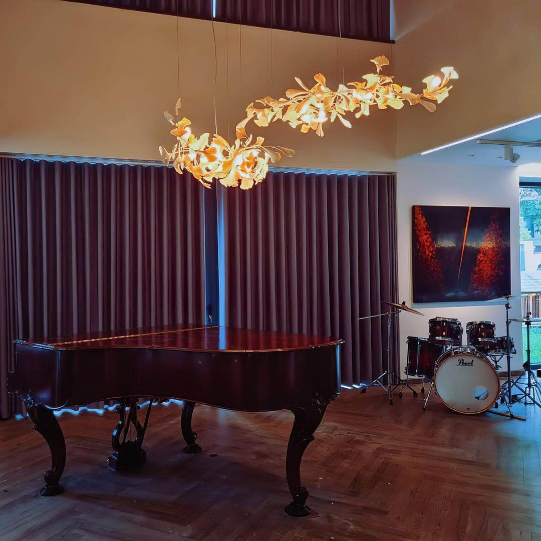 Gingko ceramic leaf chandelier glowing above a grand piano room.