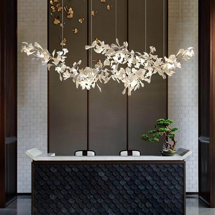 Ceramic leaf chandelier hanging above a modern reception desk.