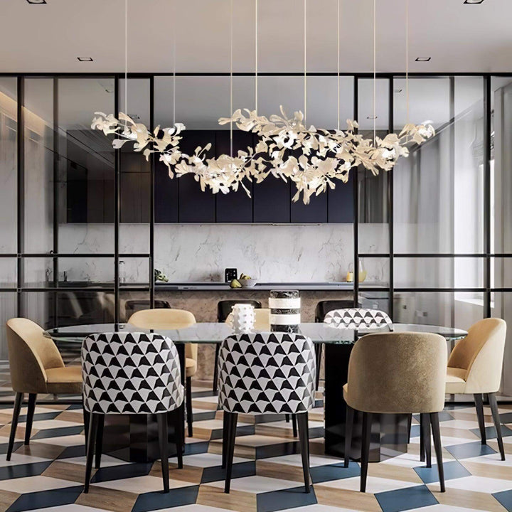 Ceramic leaf linear chandelier above a restaurant-style dining table.