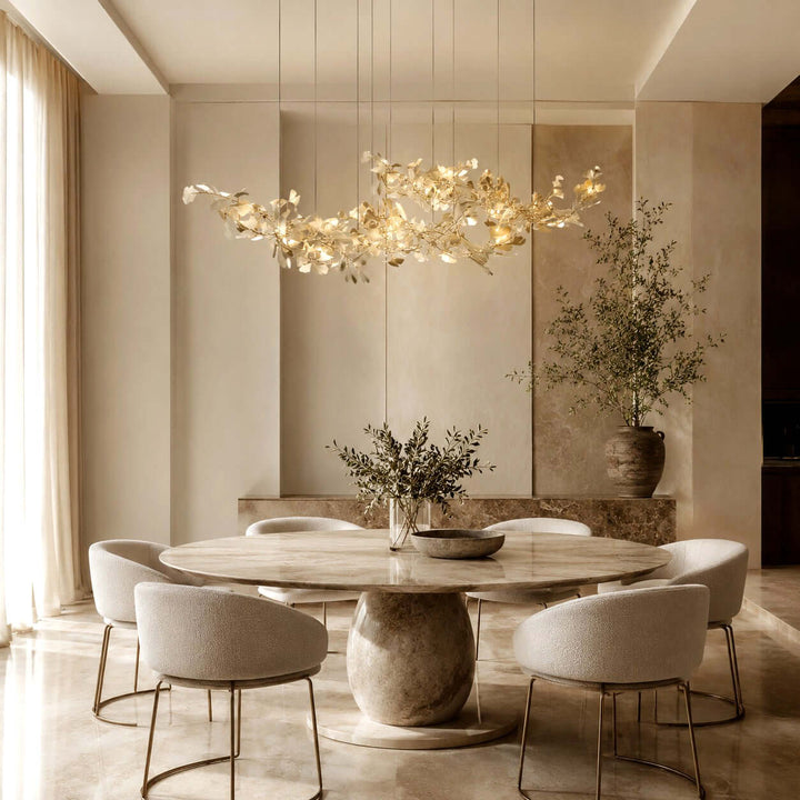 Gingko ceramic leaf chandelier above a round dining table in a bright room.
