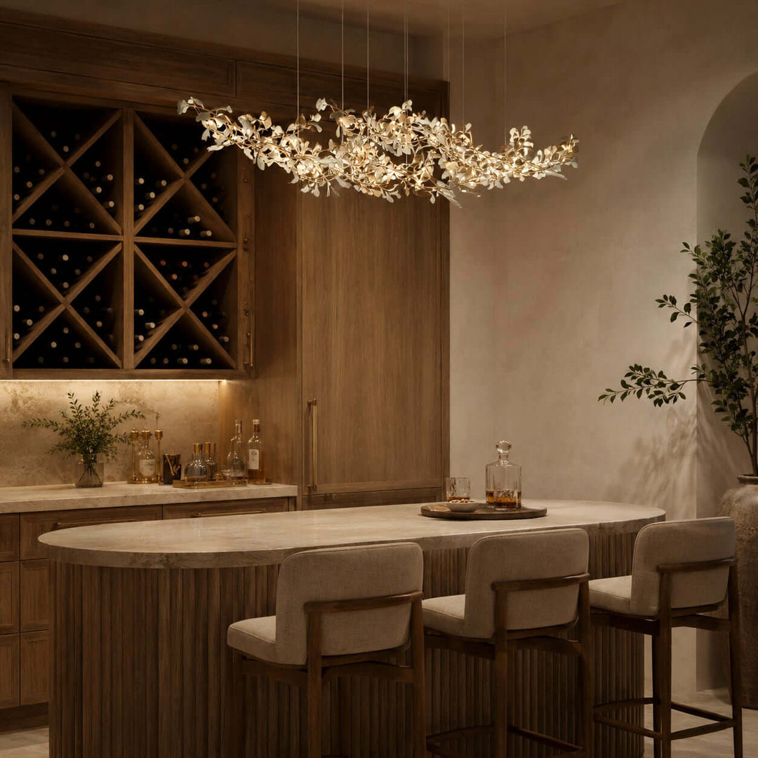 Gingko linear chandelier above a dining table near a wine cabinet.