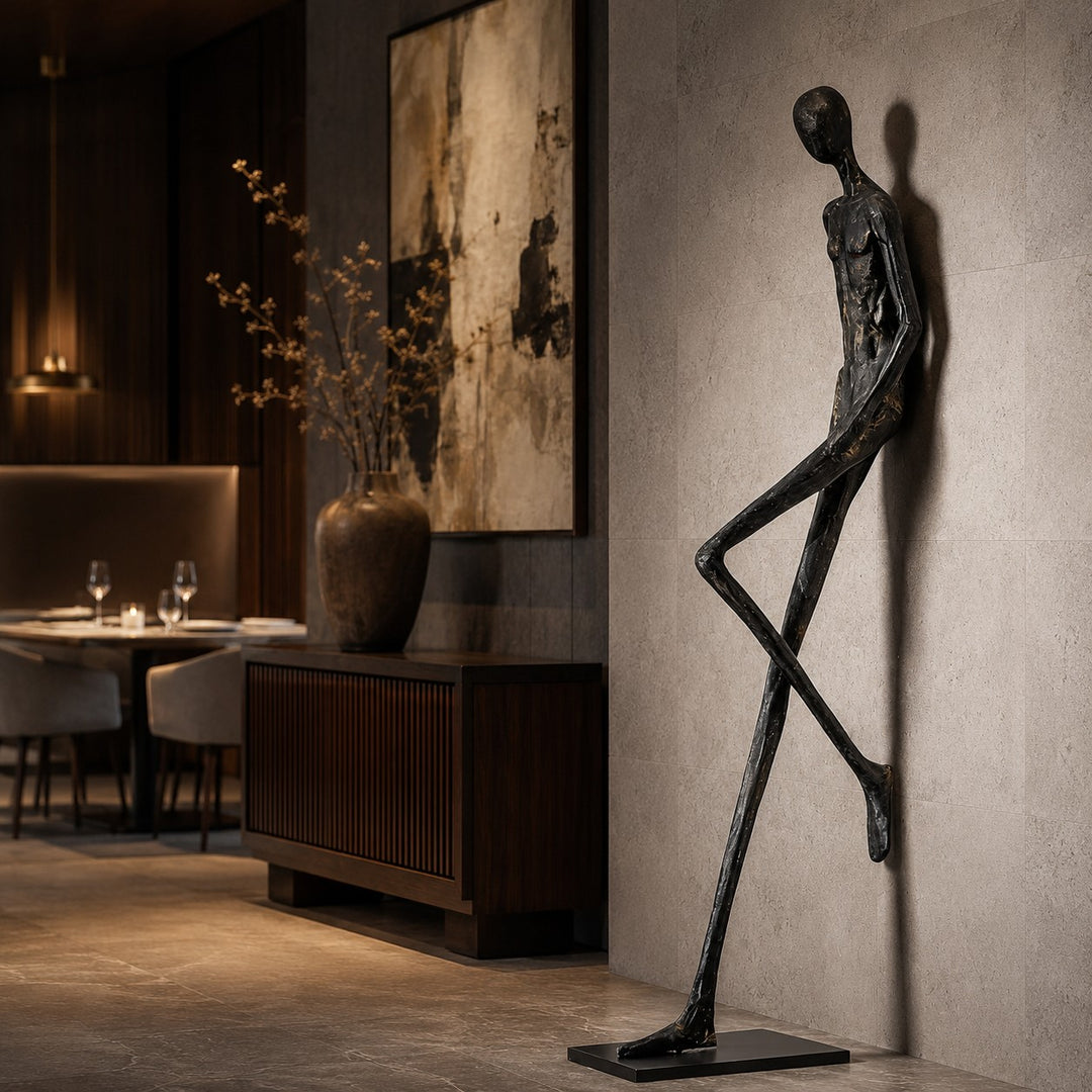 Black abstract sculpture styled near a warm dining room wall.