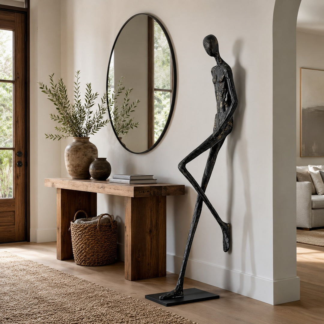 Black abstract Lemvix sculpture displayed beside an entry console and round mirror.