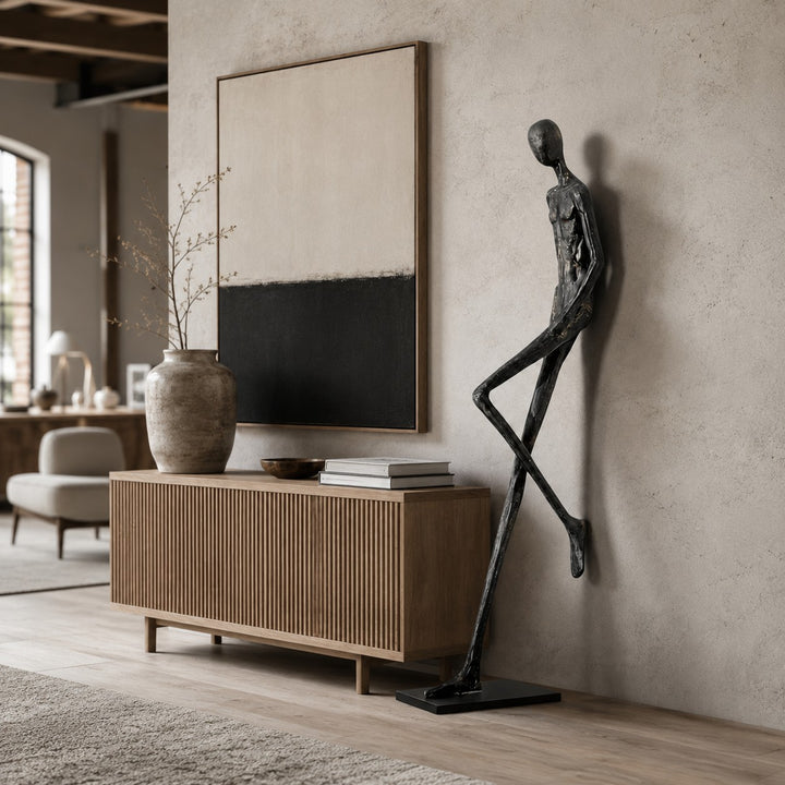 Lemvix black sculpture placed beside a media console in a living room.