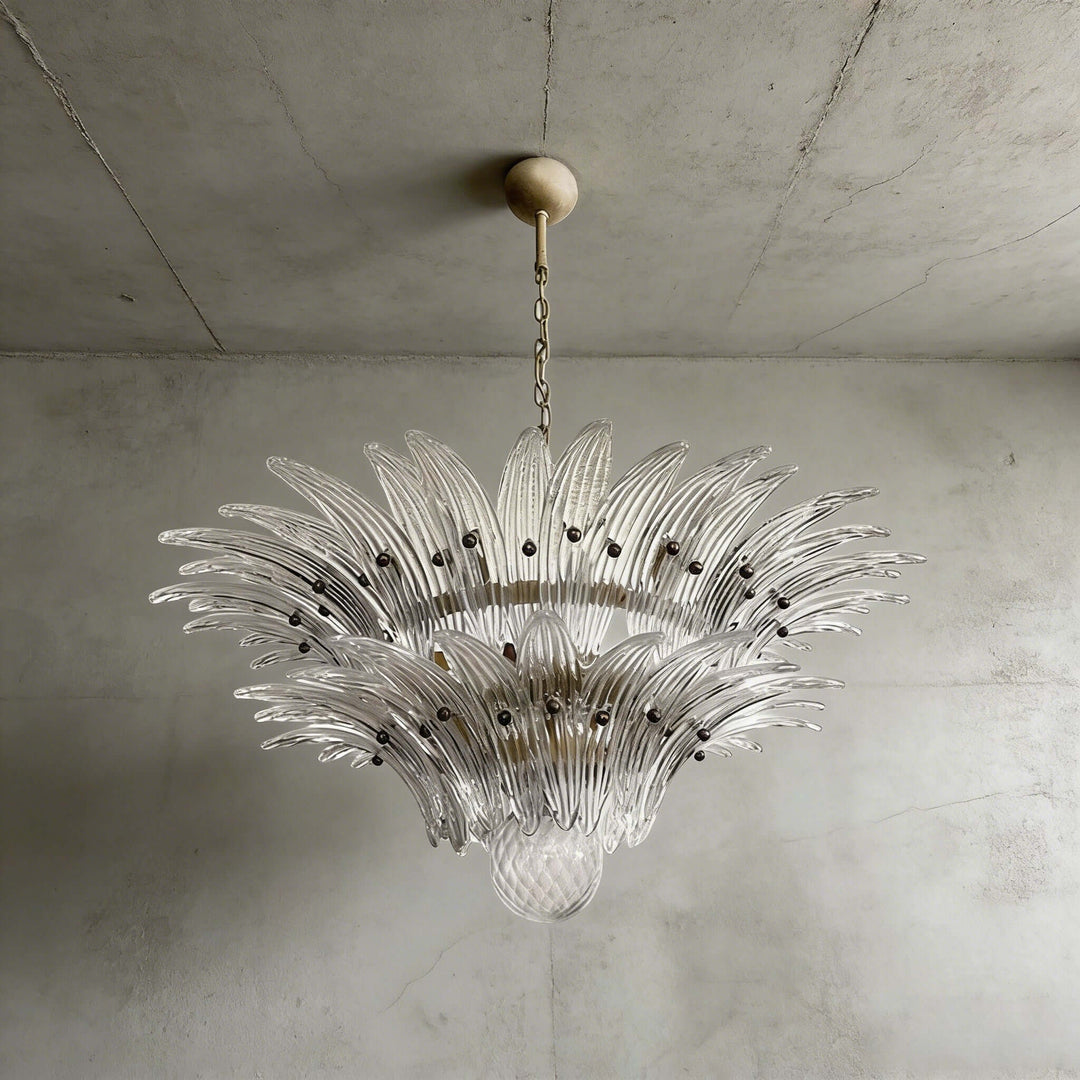 Clear glass Palmette chandelier shown in a compact studio view on a gray wall.