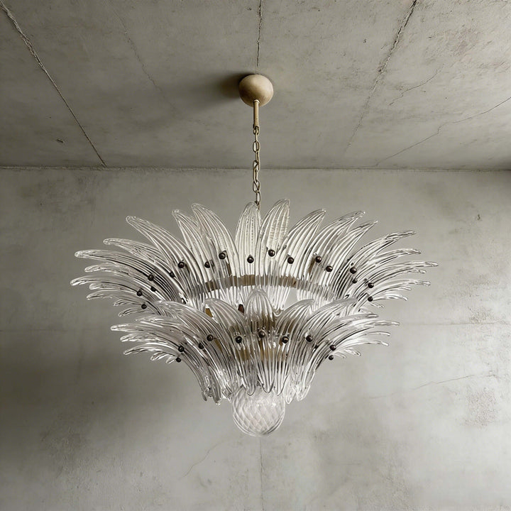 Clear glass Palmette chandelier shown in a compact studio view on a gray wall.