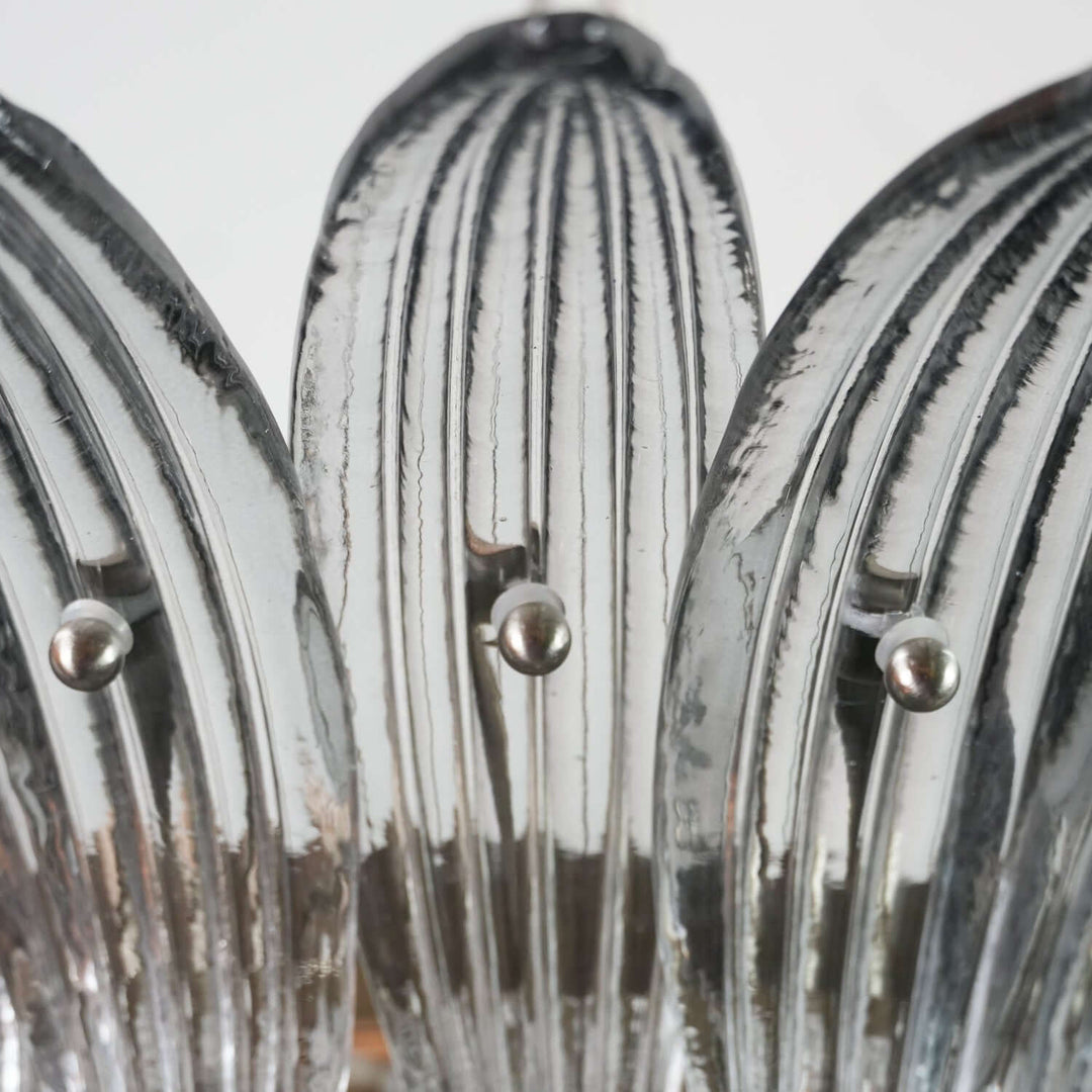 Close-up of clear ribbed glass leaves on the Murano Palmette chandelier.