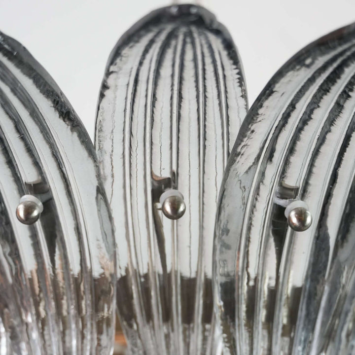 Close-up of clear ribbed glass leaves on the Murano Palmette chandelier.