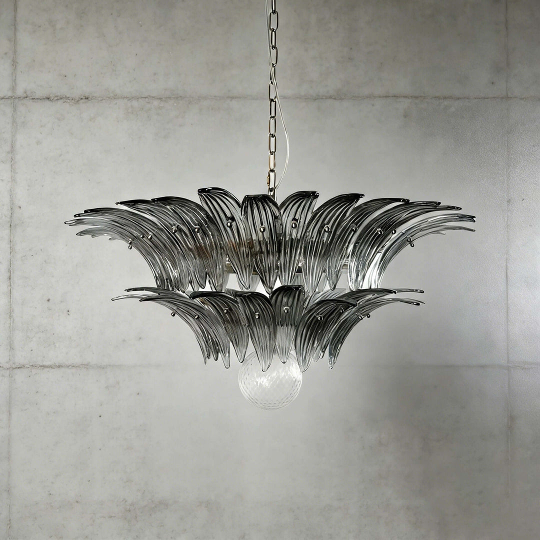 Smoky gray glass Palmette chandelier shown in a compact studio view on a gray wall.