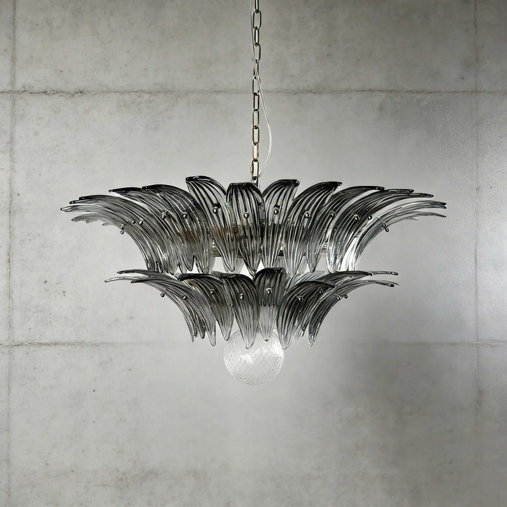 Smoky gray glass Palmette chandelier shown in a compact studio view on a gray wall.