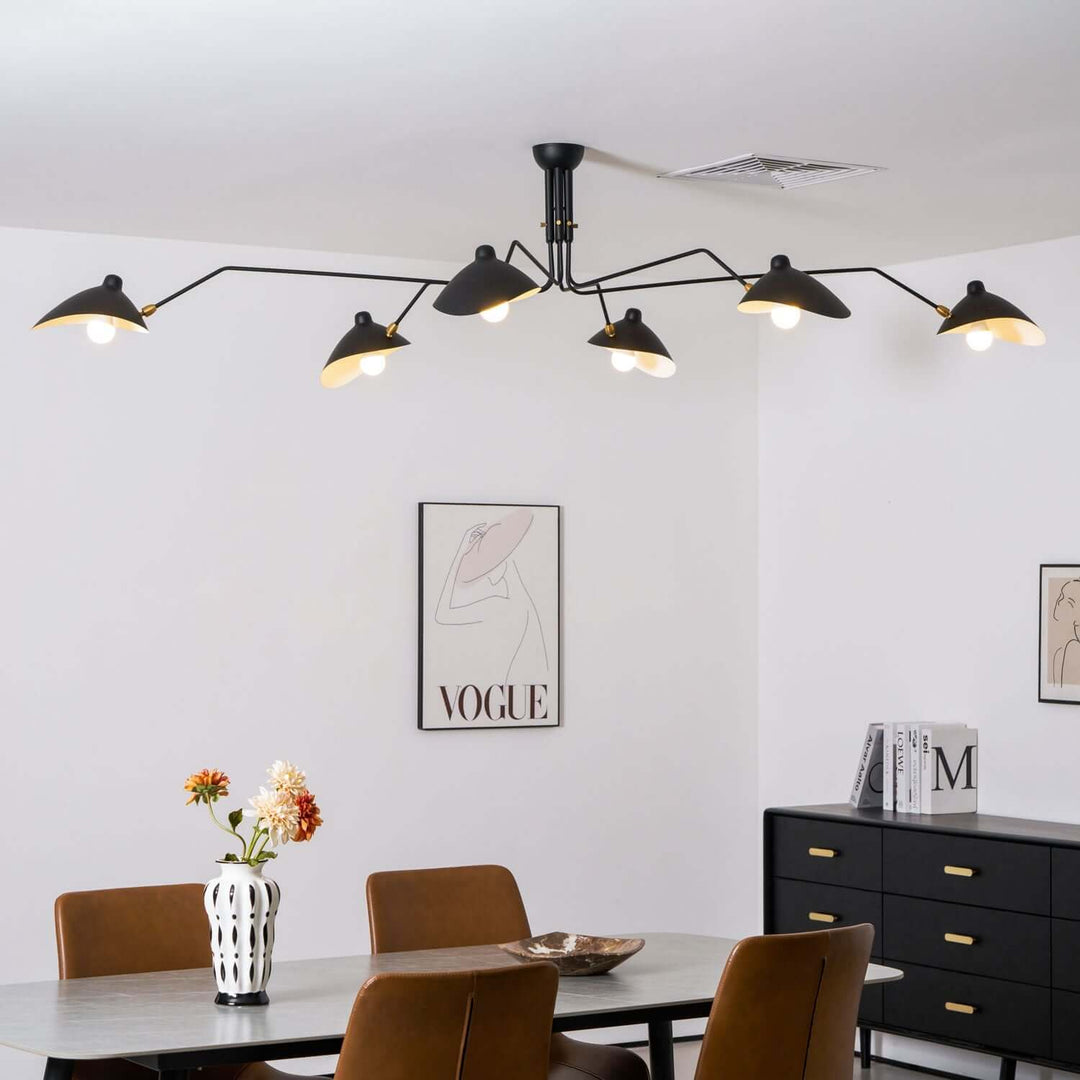 Black six-light ceiling fixture hanging over a dining table.