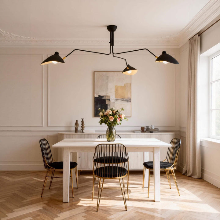 Black three-light ceiling fixture above a dining table and chairs.