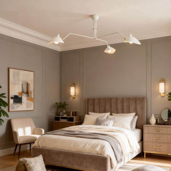 White angled-arm ceiling light installed above a warm bedroom.