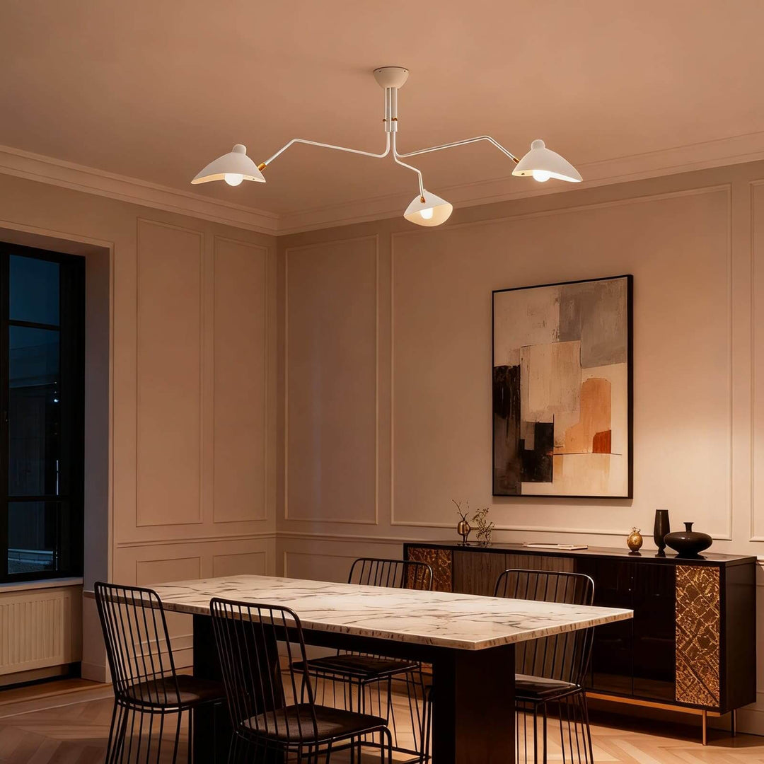 White ceiling light glowing warmly above a dining table.