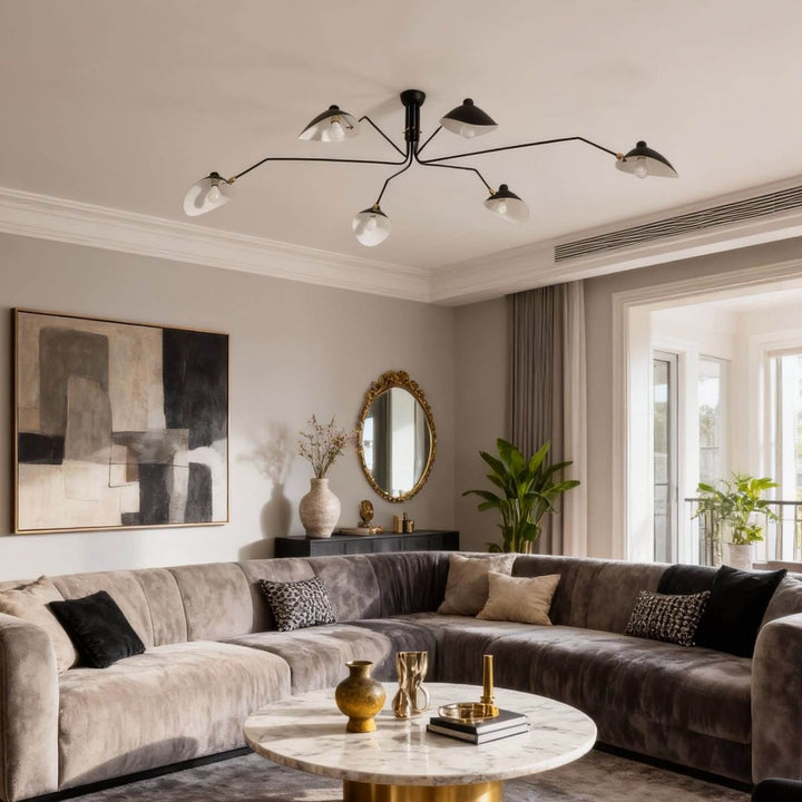 White multi-arm ceiling light installed above a modern living room sofa.