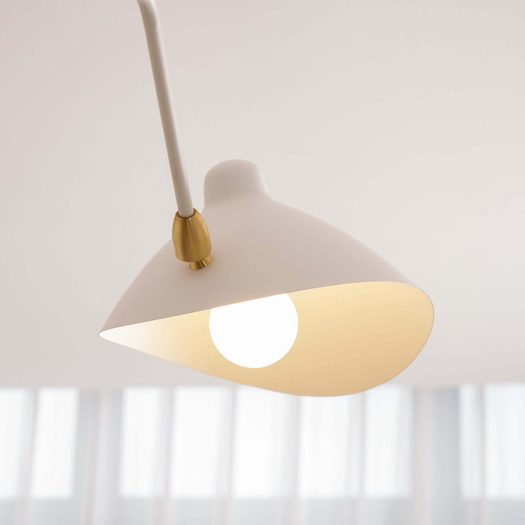 Front close-up of a white cone shade with a glowing bulb.