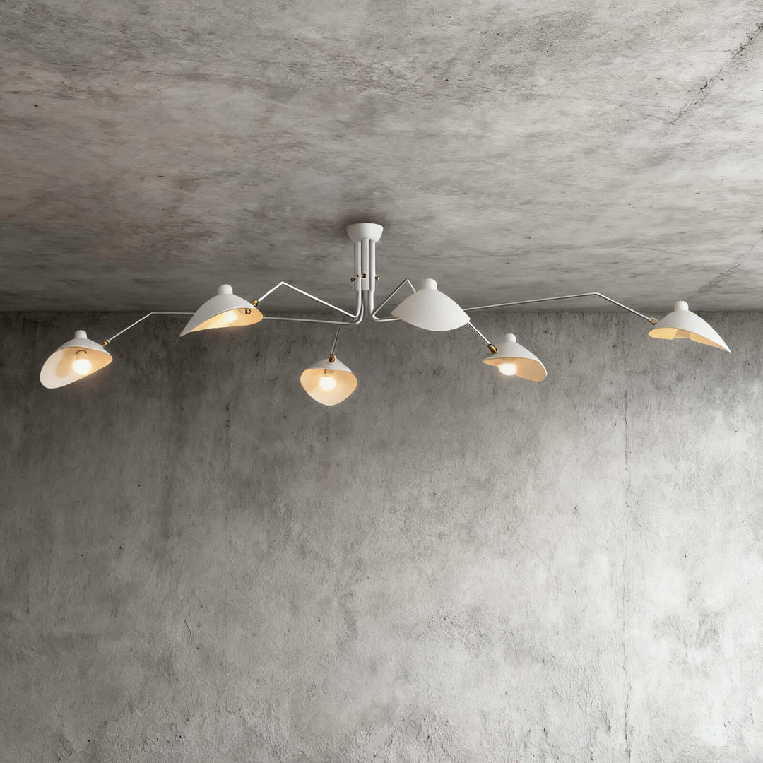 White six-light ceiling fixture with angled arms on a concrete wall background.
