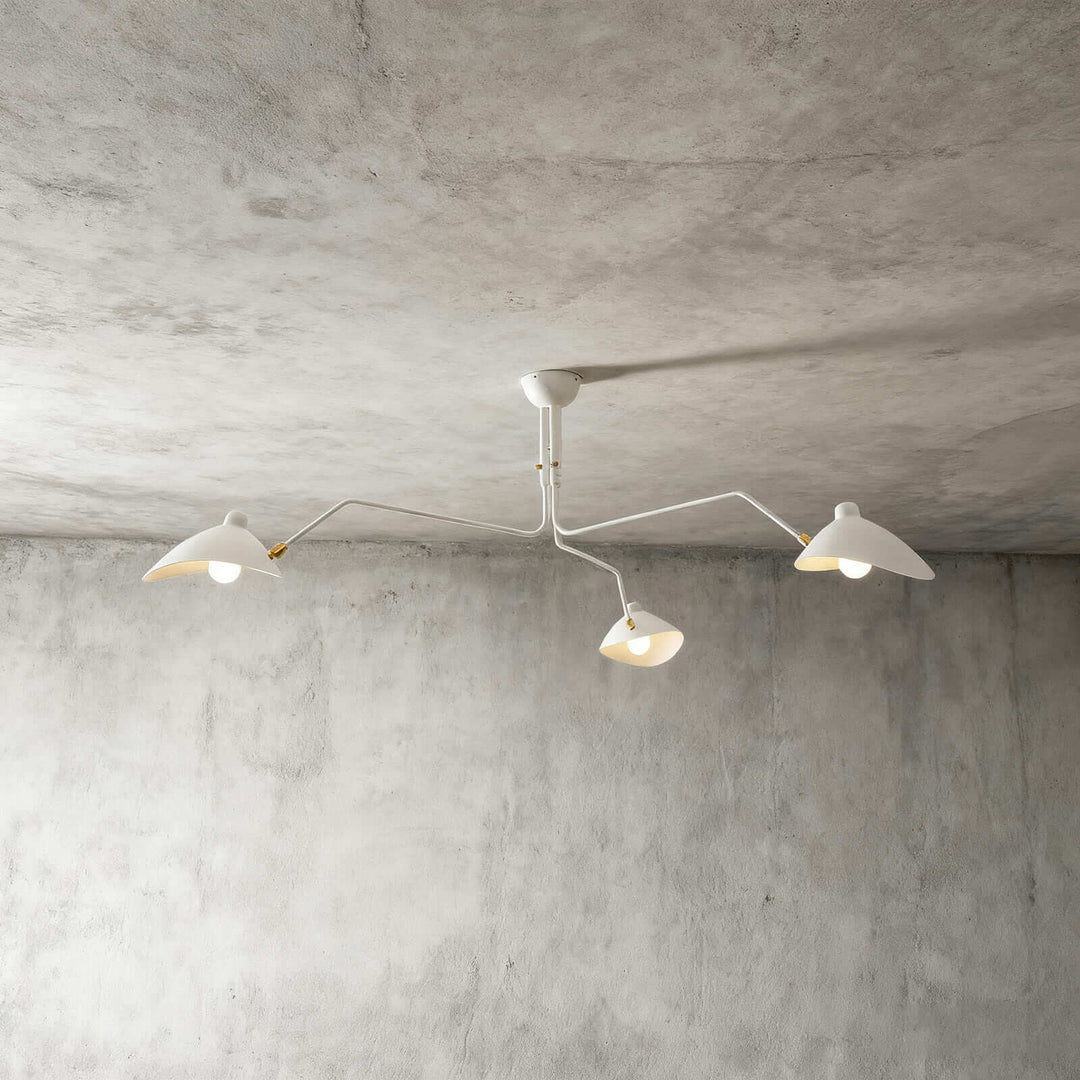 White three-light ceiling fixture shown against a concrete wall background.