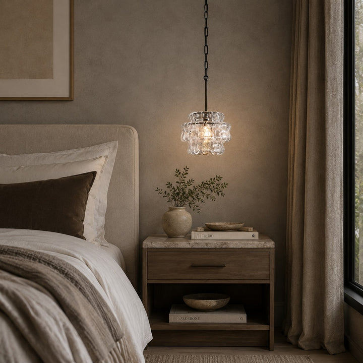 Small glass chandelier shown beside a bed near curtains and a nightstand.