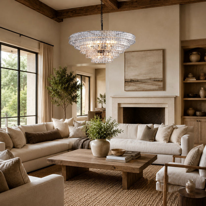 Clear glass chandelier above a living room seating area with cream sofas.
