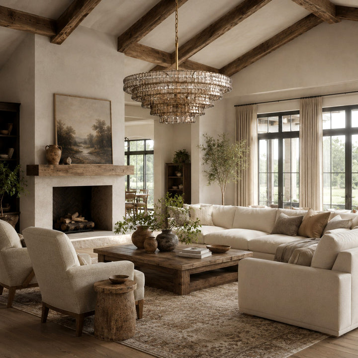 Zirvona round glass chandelier above a living room with a fireplace and sofas.