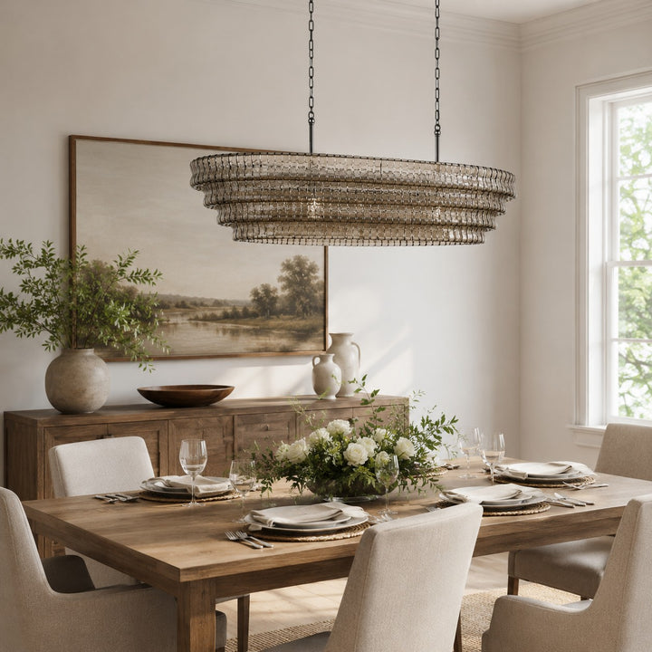 Wide round glass chandelier above a rectangular dining table in a bright room.