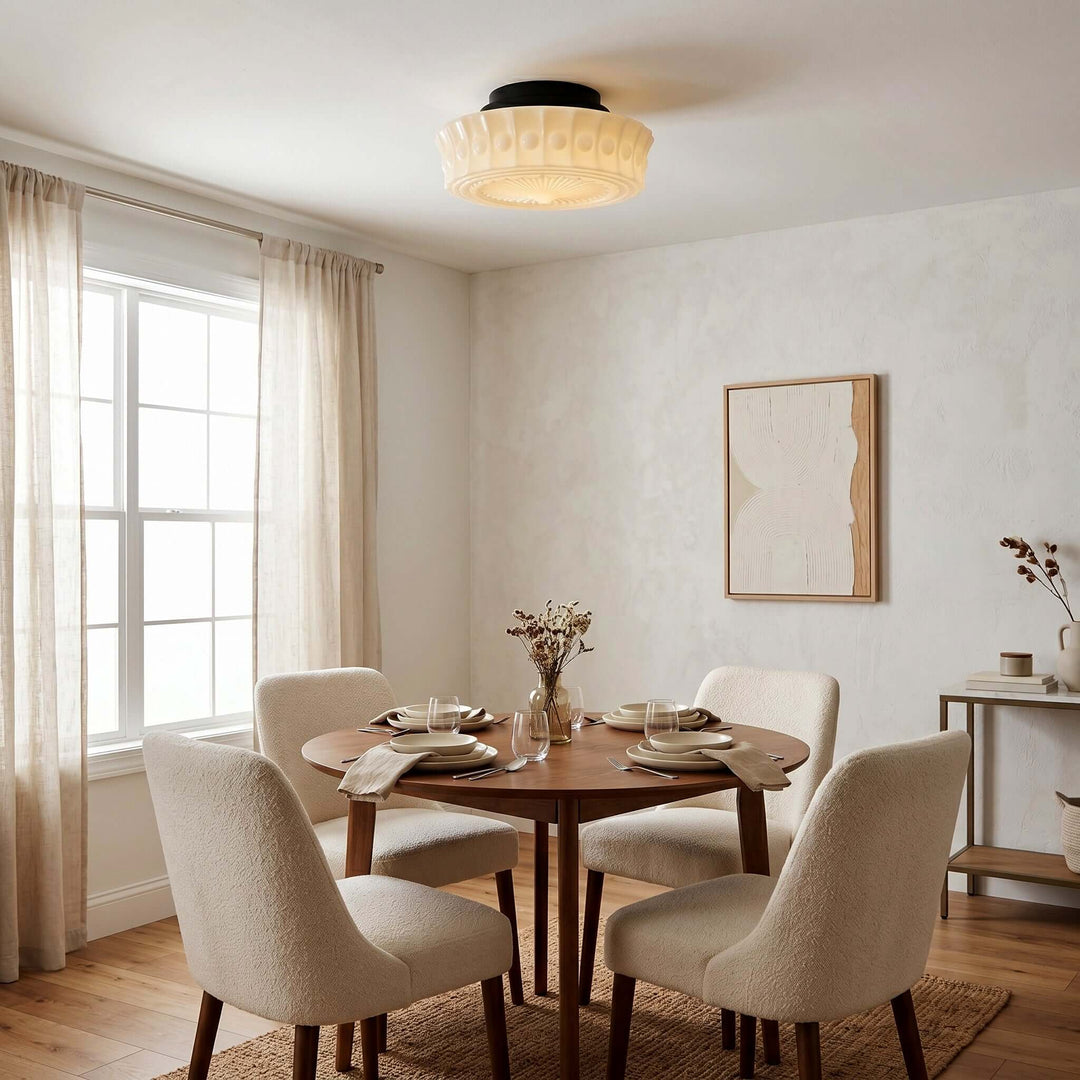 Creamy patterned milk glass ceiling light above a round wood dining table in a neutral dining room