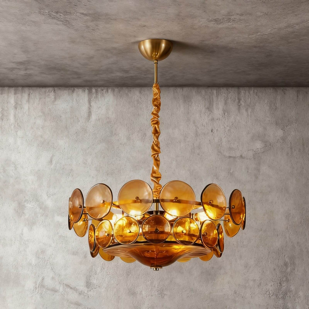 Illuminated vintage orange glass chandelier with a bronze-finish suspension